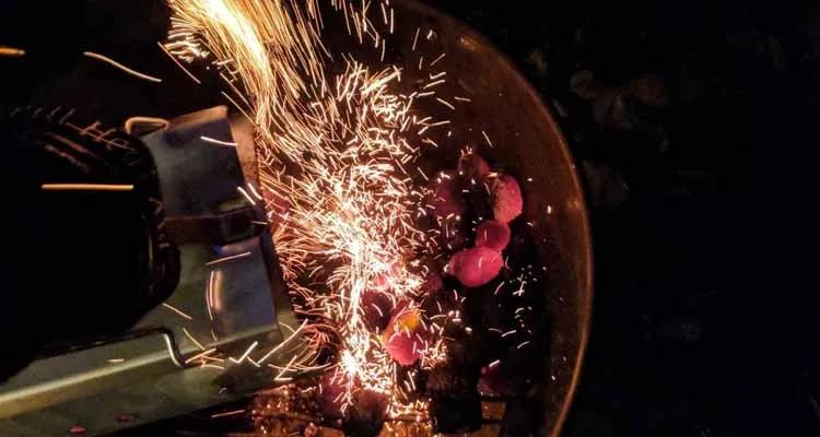 Emptying charcoal chimney into grill