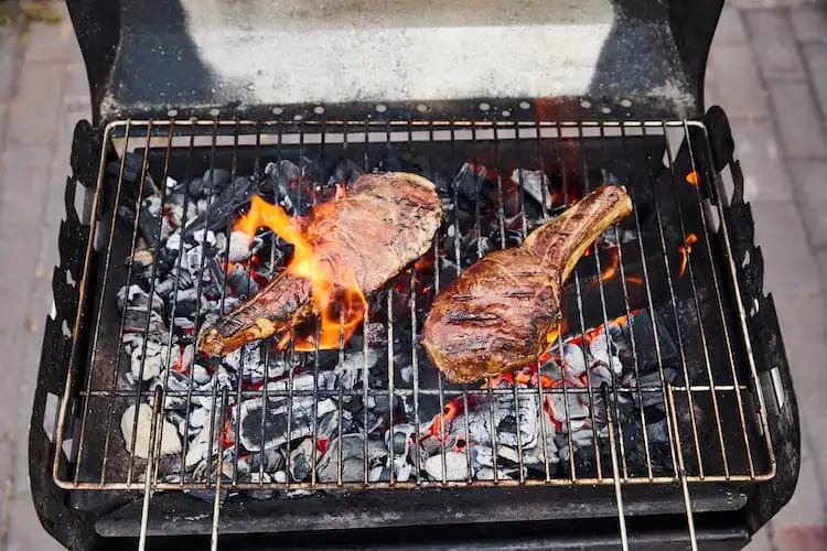 Meat grilling with some fire flare-ups